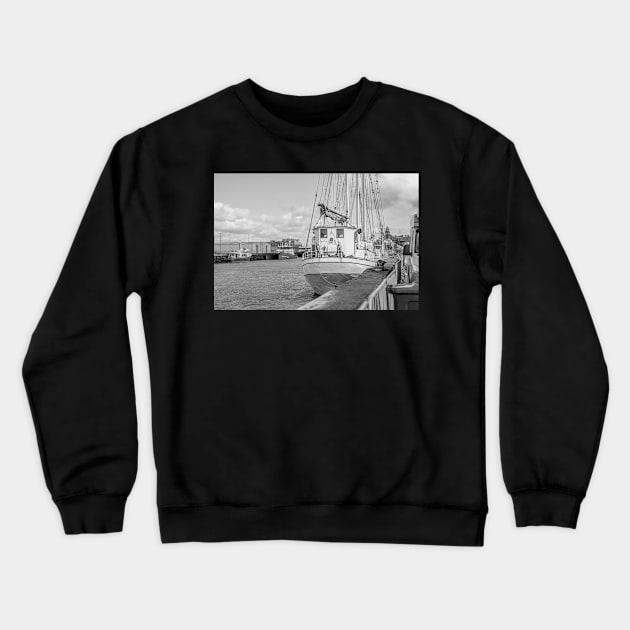 Sailing boat moored in Great Yarmouth harbour Crewneck Sweatshirt by yackers1